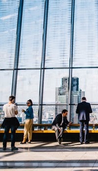 Image of city workers in atrium of tall building